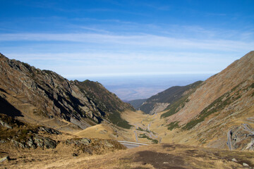 Fototapeta premium Fagaras Mountains and Transfagarasani on a blue sky background, view from the Lake Balea, Sibiu, Romania