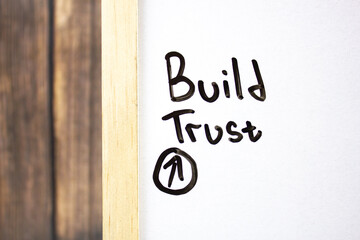 Build Trust - concept text on a white board written in black marker.