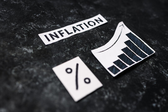 Inflation text with percentage symbol and chart with stats increasing on dark background, economic struggles after the pandemic