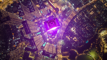 Aerial night view of Bitexco Tower, buildings, roads, Thu Thiem 2 bridge and Saigon river in Ho Chi Minh city - Far away is Landmark 81 skyscraper. Business and landscape concept.