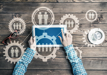 Concept of teamworking and connection with gears mechanism and tablet pc