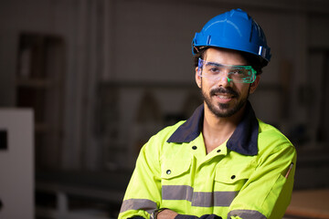 Handsome engineer using smart watch for control fluorescent smart digital glasses with futuristic holographic interface to display data and repair defects of equipment in the factory.