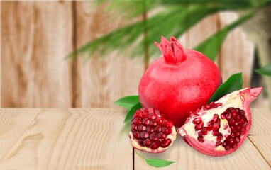 Fresh ripe tasty pomegranates fruits on the desk