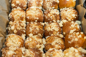 Fresh appetizing pastries in a basket on the table. Breakfasts and coffee breaks. Close-up.