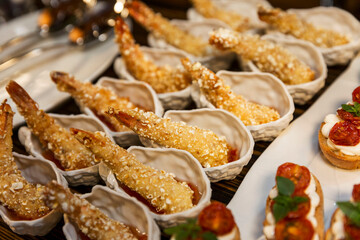 Portioned fried shrimp on the buffet table. Catering for holidays and events. Close-up.
