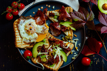 Healthy breakfast with eggs, bacon, avocado and tomatoes