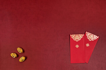 Chinese new year festival decorations with chinese gold ingots with red envelope. Copyspace.