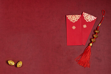 Chinese new year decorations made from chinese good fortune symbol, gold ingots and red envelopes.