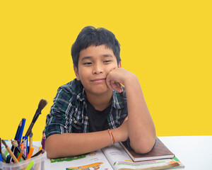 Student listening to lecture in classroom. Boy concentrating in classroom with books.