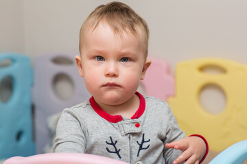 Little baby's angry face. Portrait of a beautiful child, close up. 