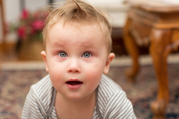 Little baby's surprised face. Portrait of a beautiful child, close up. 