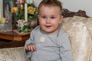 Little baby sits on the vintage armchair. Portrait of smiling baby boy. Little baby sits on the vintage armchair. Portrait of smiling baby boy. 