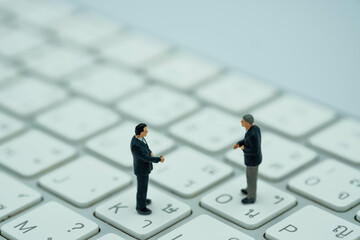 Miniature business man stand on a keyboard , thai language keyboard