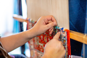 The silk carpets are knotted by hand in Uzbekistan. They are fine and expensive.