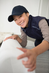 Obraz premium professional female worker rolling carpet