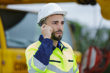 construction worker listening to instructions via walkie-talkie