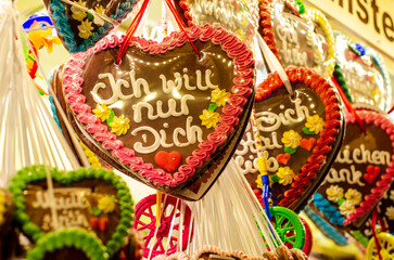 Fototapeta premium Gingerbread Hearts at German Christmas Market. I just want you - inscription in German
