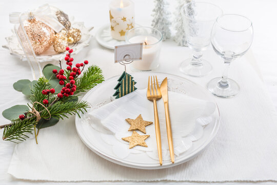 Christmas table setting with cutlery in white tone