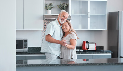 Love, marriage and dance with a senior couple in the kitchen of their home together for bonding or...