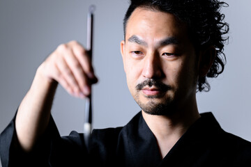 Image like a Japanese calligrapher 「shodo」holding a brush. closeup