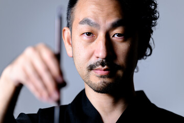 筆を持っている書道家のようなイメージ