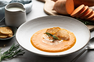 Sweet potato soup in a ceramic bowl, selective focus