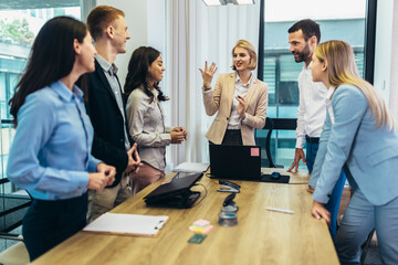 Office colleagues having discussion during meeting in conference room. Group of men and women in conference room.