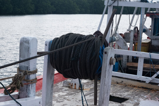 selectively focus on the reel of rope to pull the fishing boat anchor