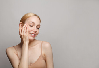 Female face closeup studio portrait. Young attractive woman spa wellness model on white background. Facial treatment, cosmetology, skincare and beauty concept