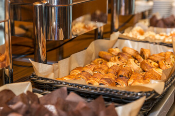 Assortment of fresh pastries on the buffet table. Breakfasts, coffee breaks and activities. Close-up.