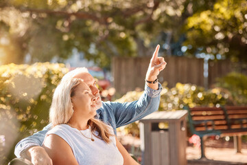 Mature, couple and man and woman bonding in the park enjoying the view while relaxing on a bench....