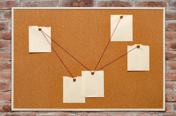 The detective's corkboard is hanging on a brick wall. Copy space.
