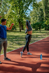 Pretty couple working out in the park