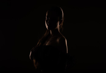 Fototapeta na wymiar Silhouette of a girl holding her hair