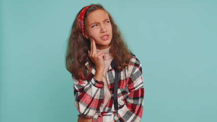 Fototapeta premium Dental problems. Teenager child girl kid touching cheek, closing eyes with expression of terrible suffer from painful toothache, sensitive teeth, cavities. Preteen children on studio blue background