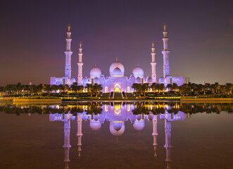 Tourists visit the Sheikh Zayed Grand Mosque. Night time view opposite the grand mosque. 