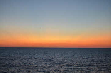 Naklejka na ściany i meble Sun is gone Dawn at Sea colorfull Ocean Horizon