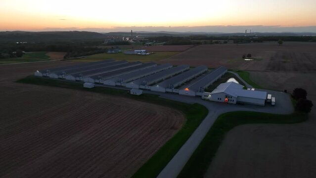 Chicken farm at night. Poultry houses in rural USA after sunset. Aerial view.
