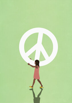 Girl carrying large peace sign
