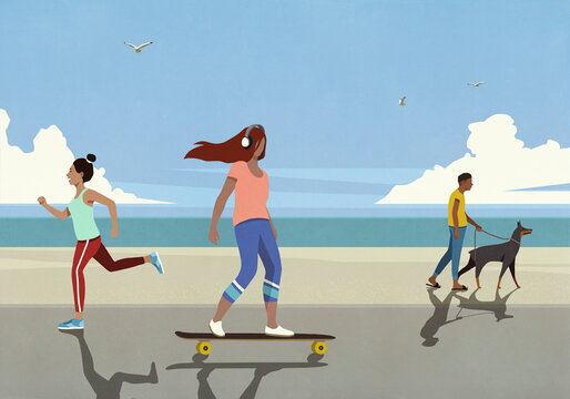 People skateboarding, jogging and walking dog on beach boardwalk
