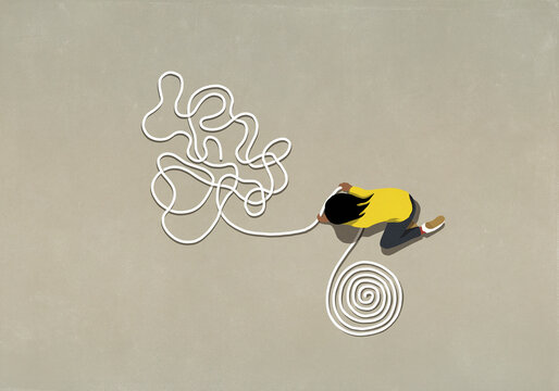 Girl untangling rope into a coil

