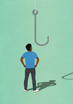 Man looking up at fishing hook
