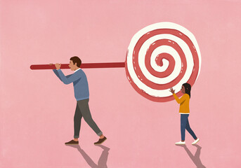 Father and daughter carrying large lollipop on pink background
