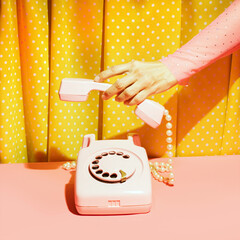 Old fashioned rotary dial telephone and female hand, creative nostalgic layout, retro aesthetic,...