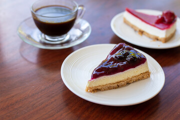 strawberry cheesecake and blueberry cheesecake on white plate.
