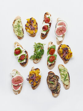 Still life variety fruit and vegetable toast appetizers on white background
