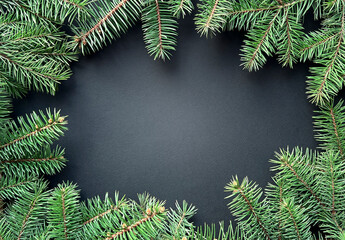 Frame from fir branches on a dark background. Winter or New Year design. Christmas card, frame. Flat lay,  copy space.