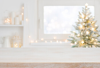 Empty table in front of christmas tree with decoration background