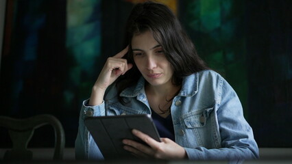 Woman using tablet device at home. Person holding modern technology browsing internet online