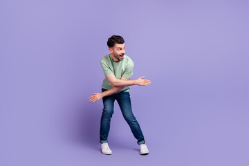 Fototapeta na wymiar Full length photo of funky good mood boy person look empty space hand crossed dancing nightclub isolated on purple color background